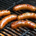 How do you keep brats warm and moist after cooking?