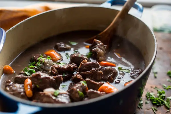 Should the stew be covered when cooking?
