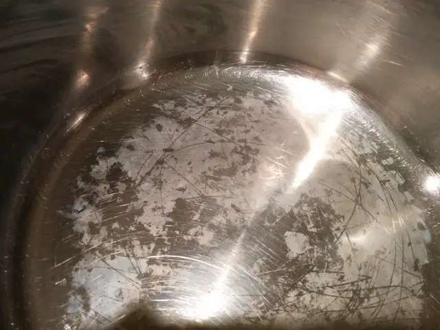 quick answer what is the white residue left after boiling water